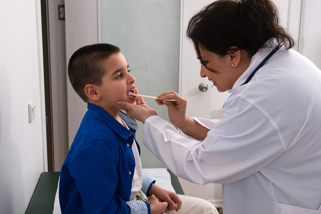 doctor looking in child's throat